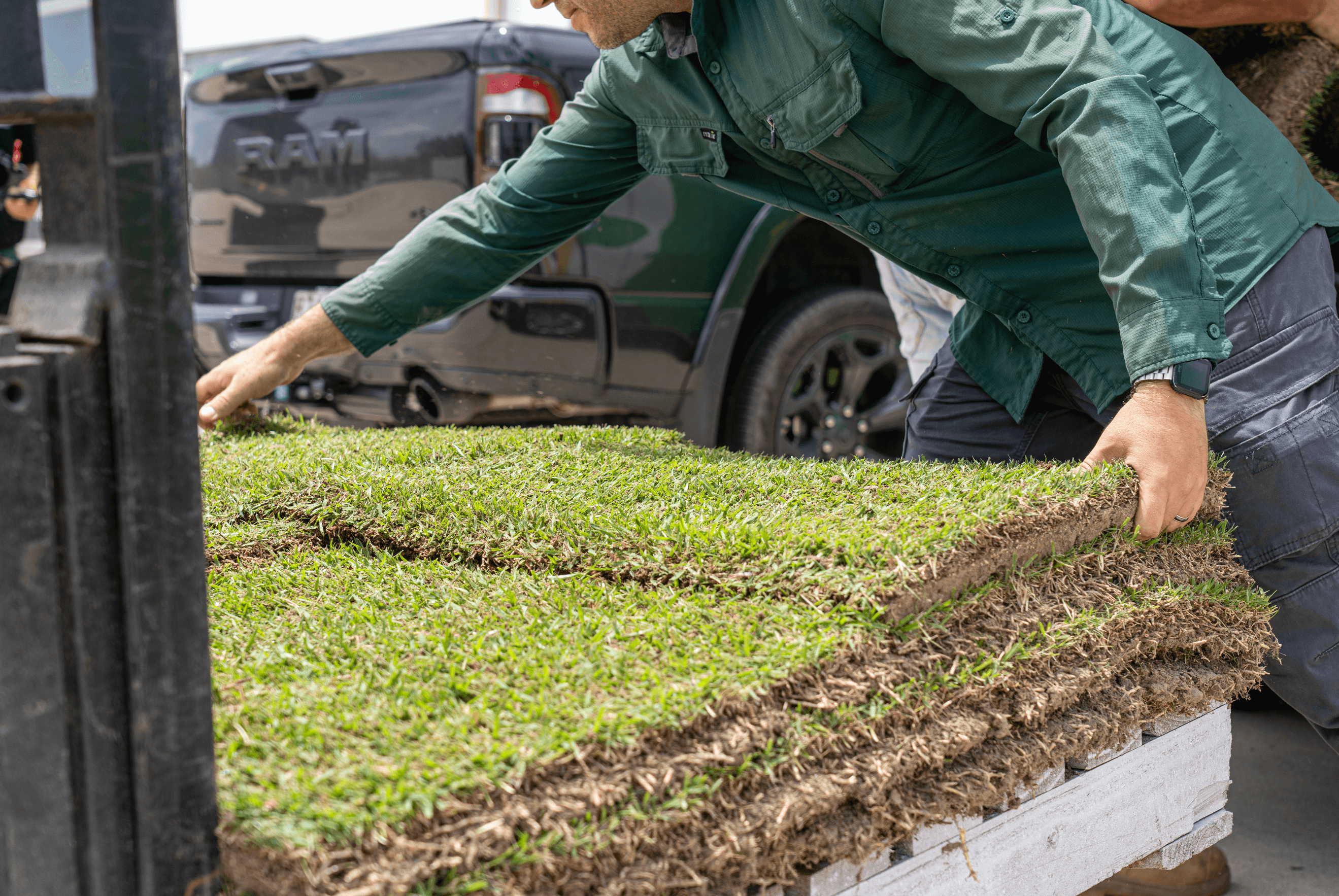 A Go Turf trade account holder lifting turf slab outside of Brendale, Brisbane storefront